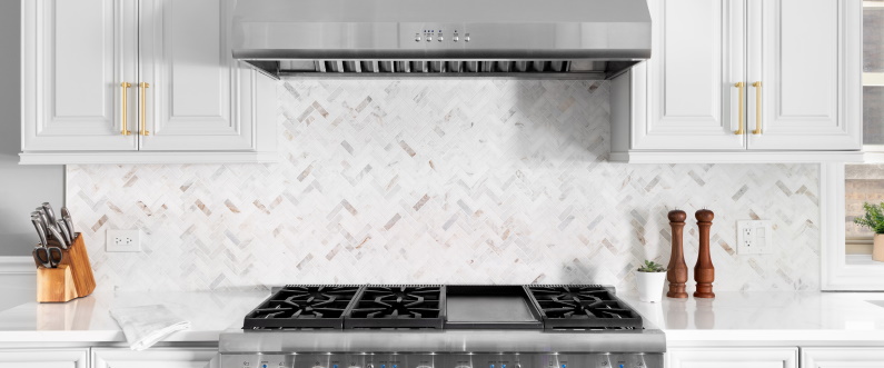 oven range and white chevron tile backsplash