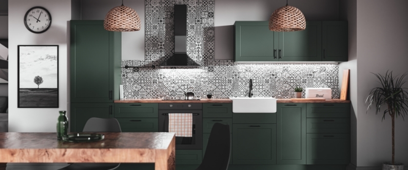 green, stylish kitchen with black and white patterned backsplash
